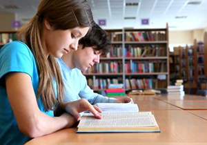 two-teens-studying-at-library